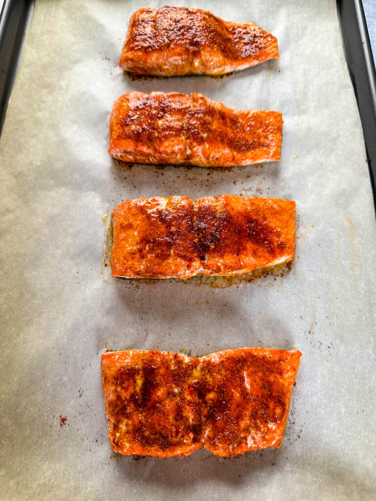 baked salmon on a sheet pan with parchment paper