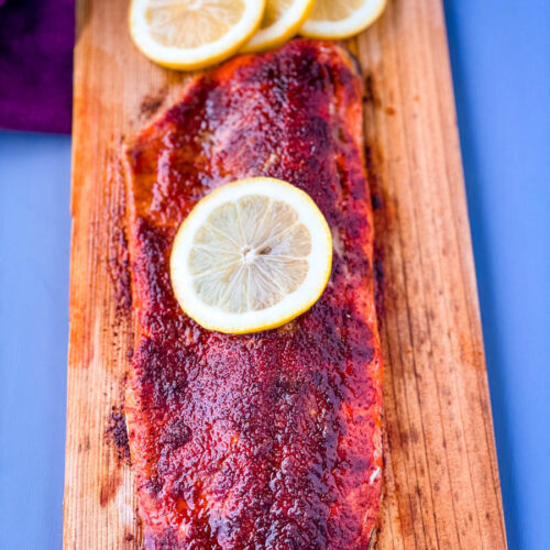 grilled salmon on a cedar plank with lemon