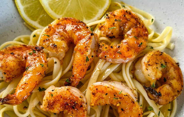 pan seared shrimp with lemon butter and pasta in a white bowl