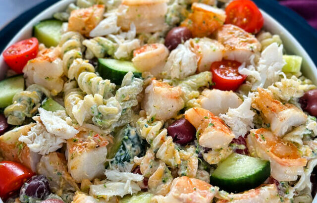 seafood pasta salad with shrimp and crab in a white bowl