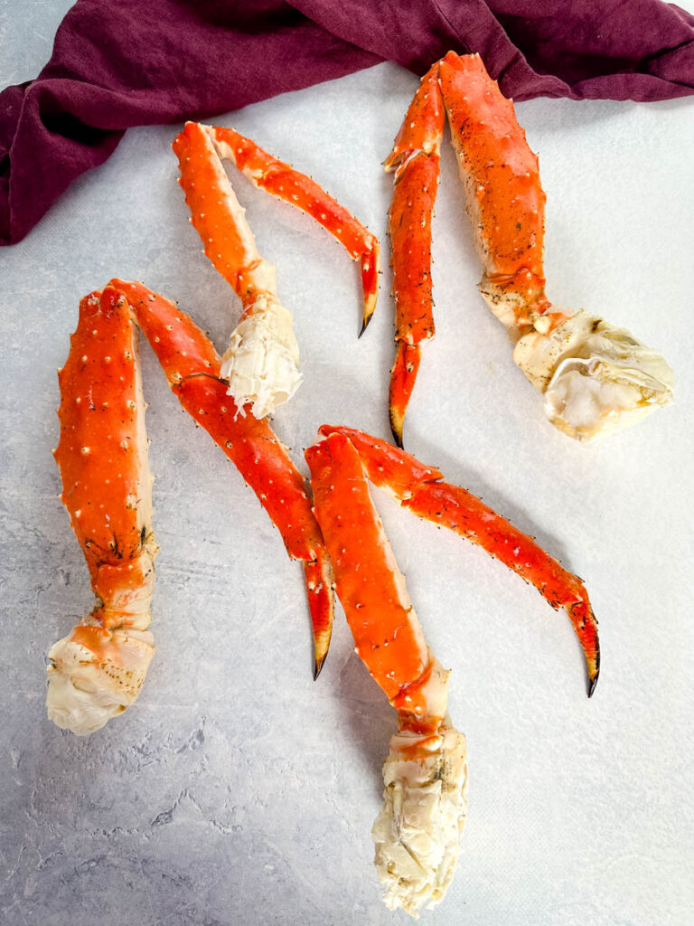 fresh king crab legs on a flat surface