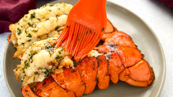 cooked butterflied lobster tail brushed with butter