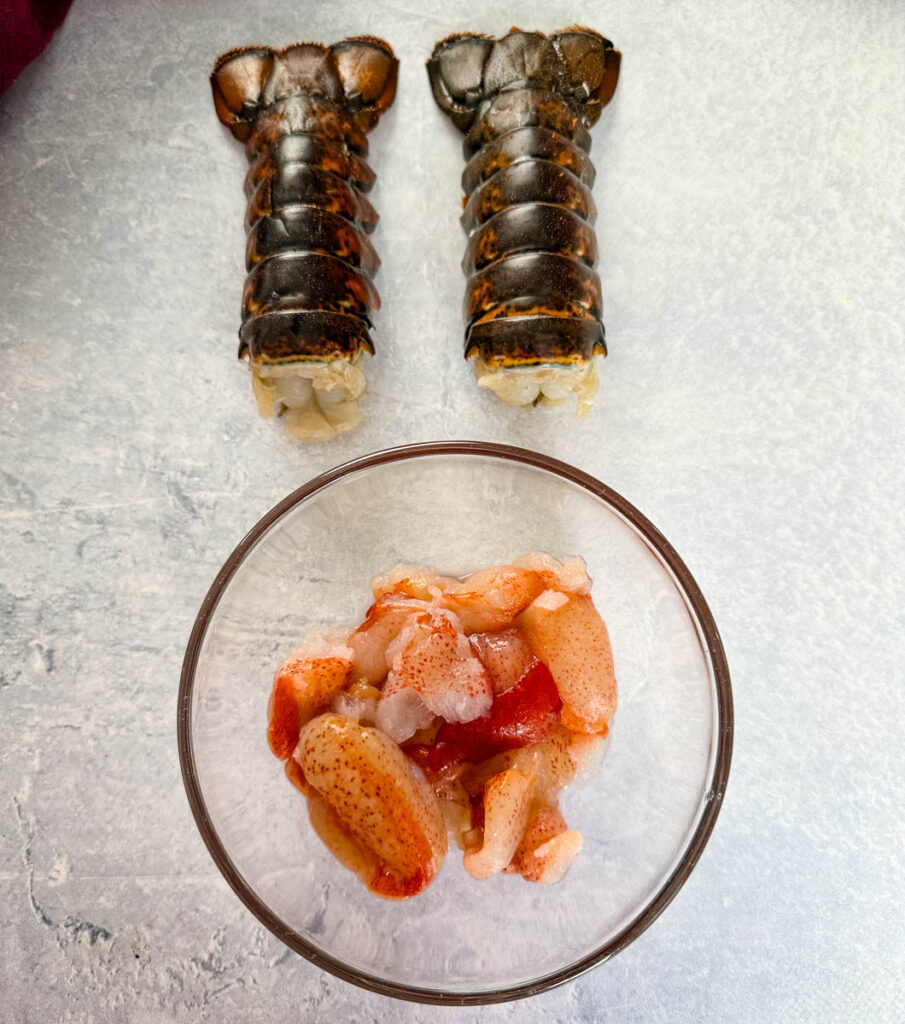 fresh lobster tails and lobster meat on a flat surface