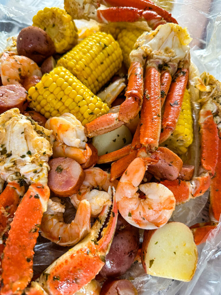 seafood boil in a bag wih snow crab clusters, shrimp, potatoes, corn on the cob and sausage