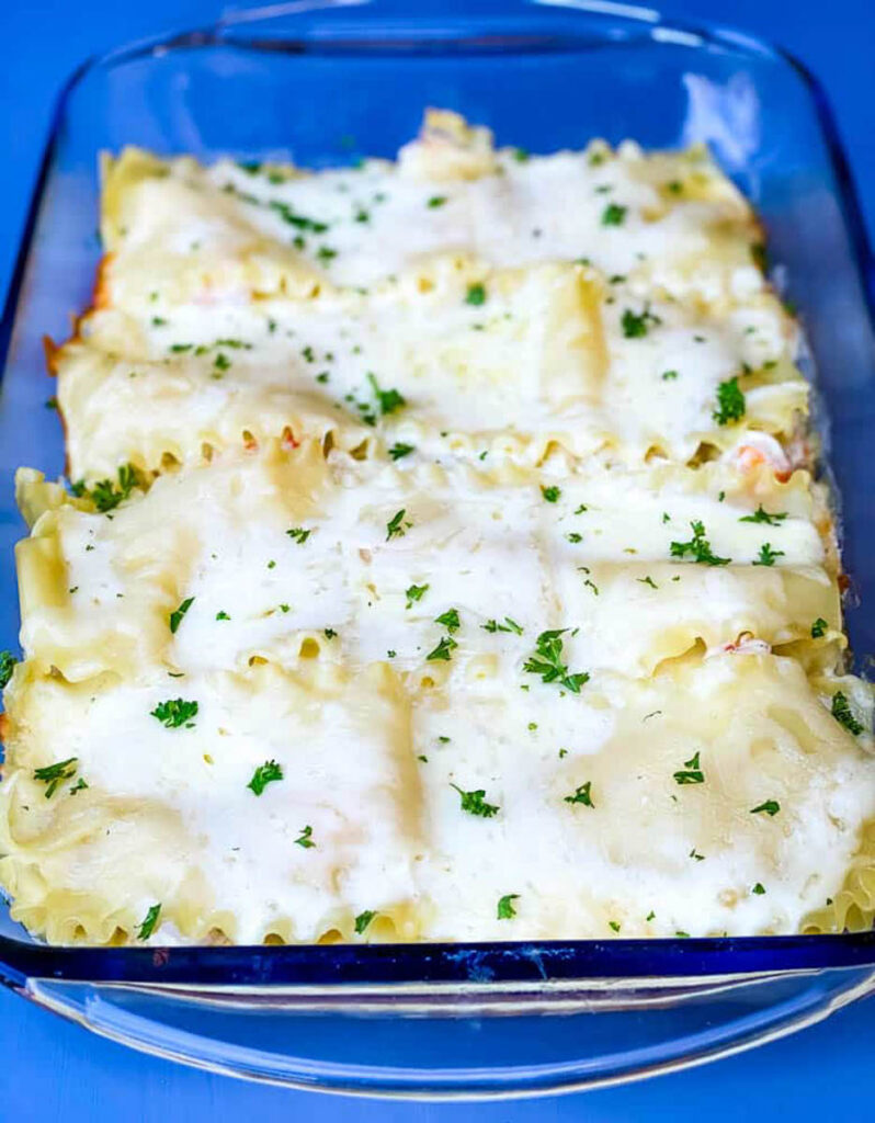 baked seafood lasagna in a glass baking dish
