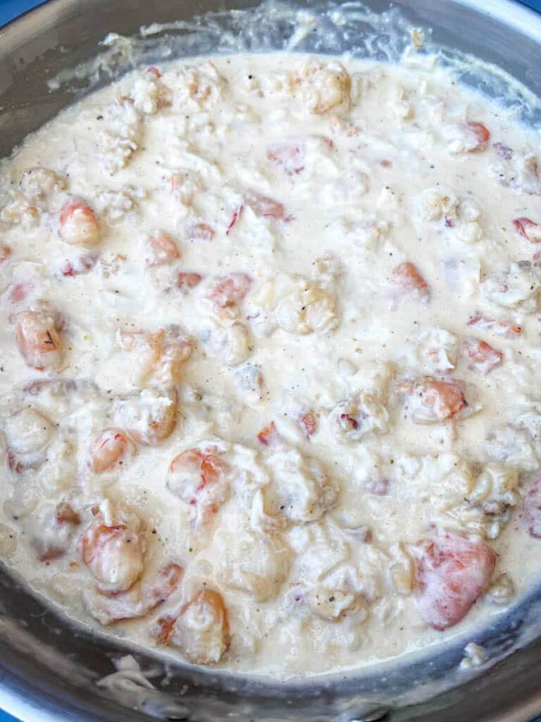 shrimp, crab, and lobster cream sauce in a pan