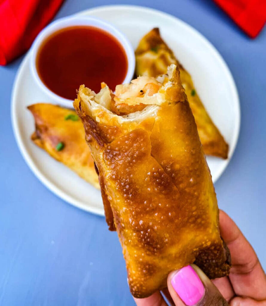 person holding shrimp egg roll