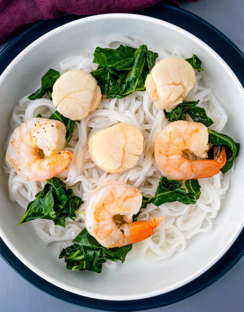 shrimp noodle soup in a white bowl