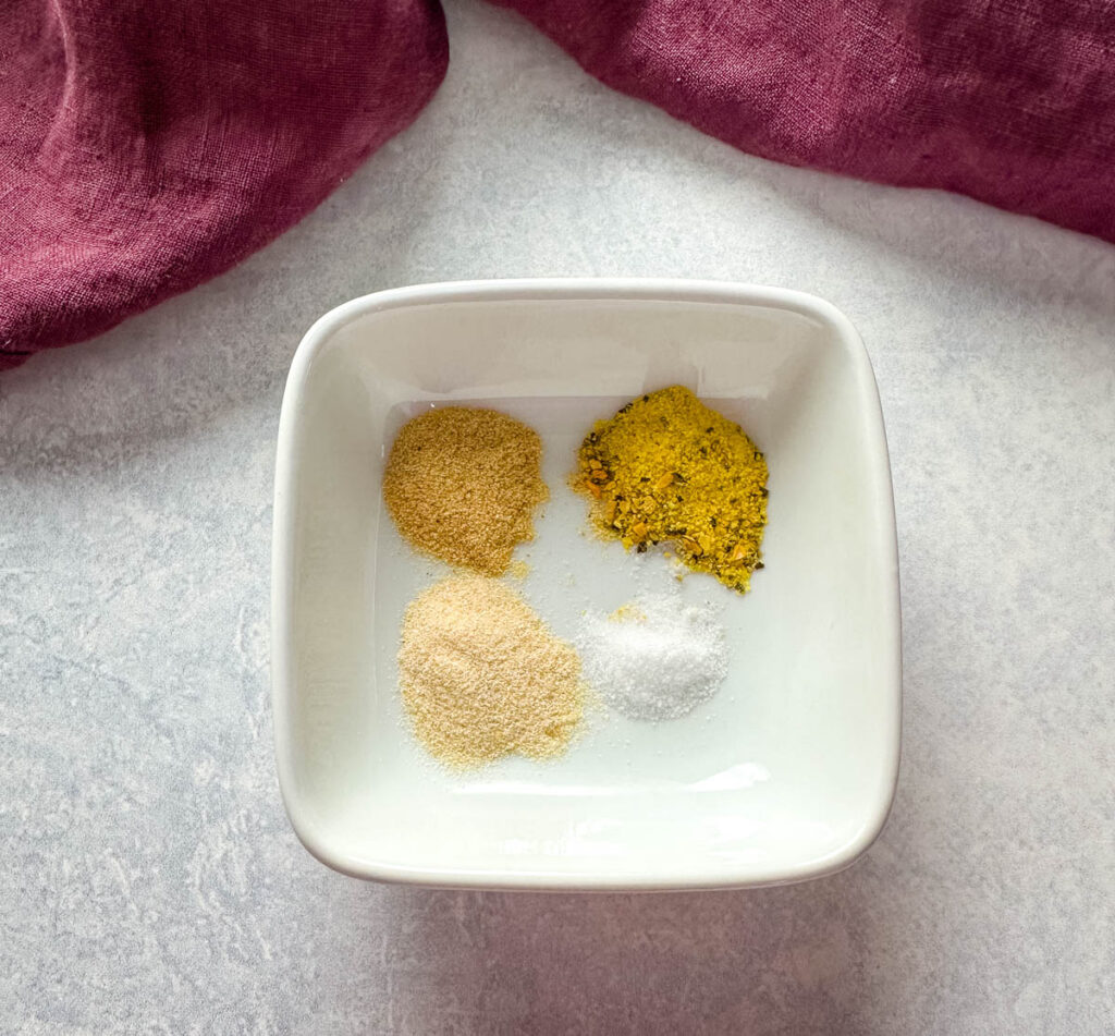 lemon pepper, garlic powder, onion powder, and salt in a white bowl