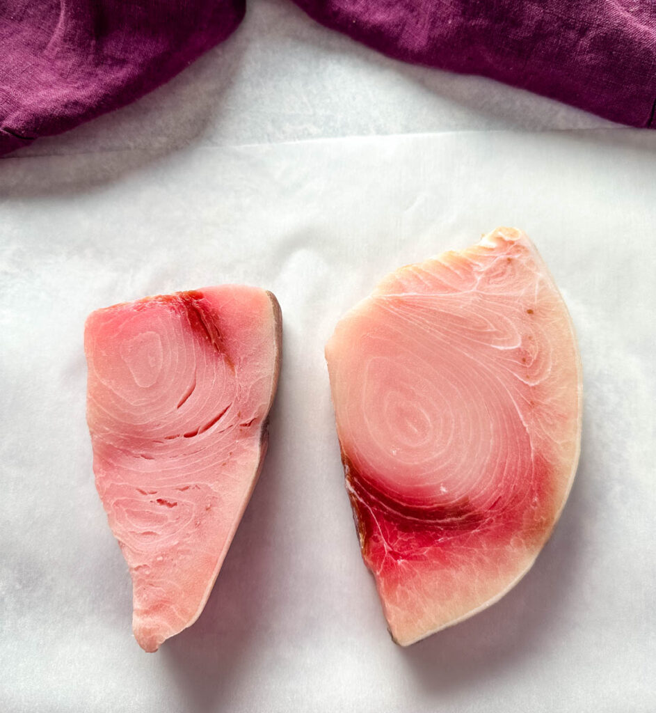 raw swordfish steak fillets on a flat surface