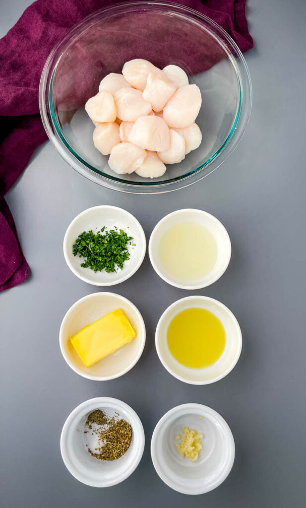 raw scallops, butter, parsley, lemon juice, and spices in separate bowls