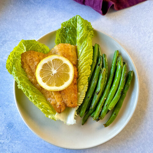 air fryer cod fish on lettuce with green beans