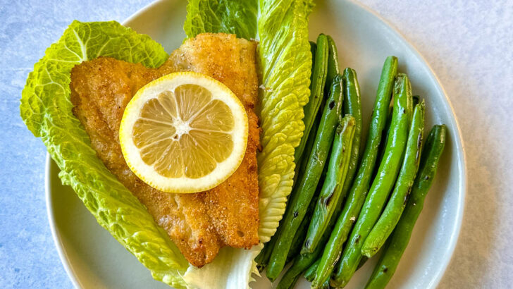 air fryer cod fish on lettuce with green beans