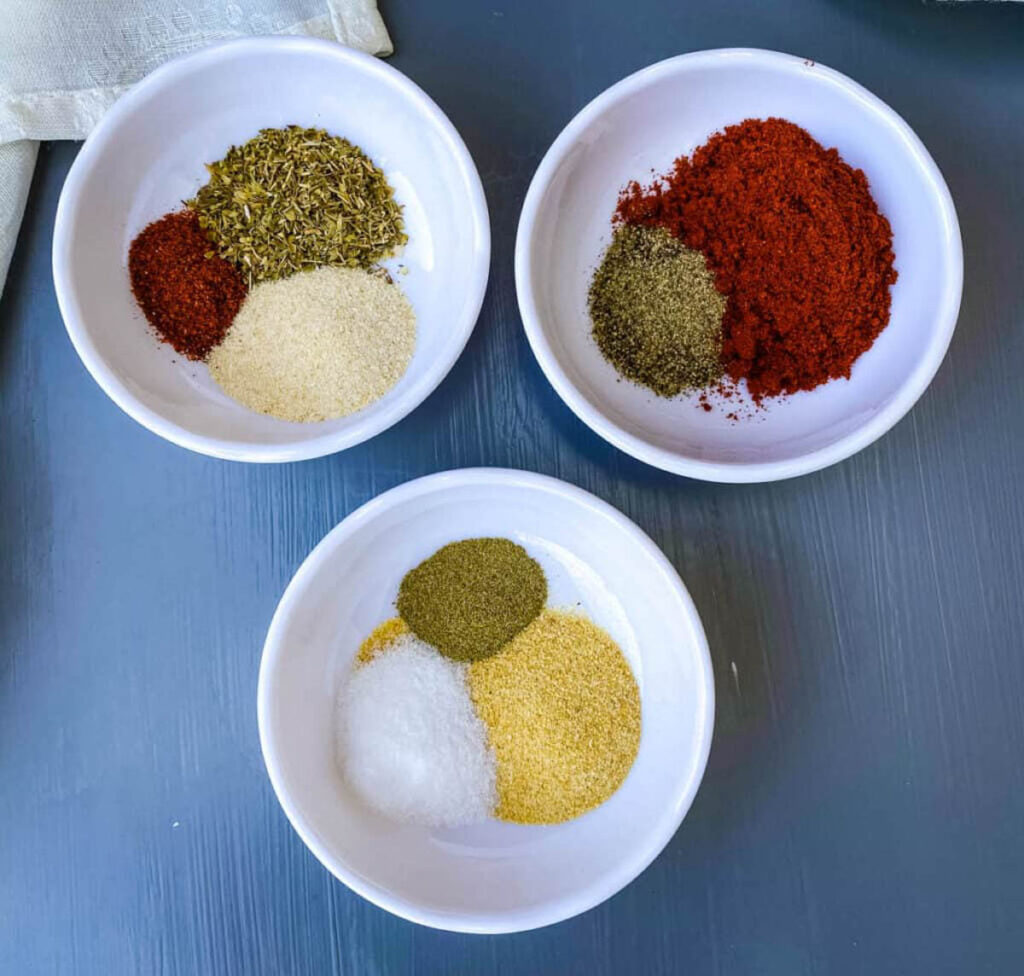 homemade Cajun seasoning spices in separate white bowls