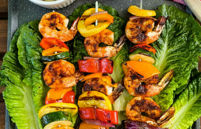 bbq shrimp skewers on a bed of lettuce