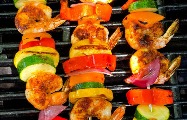 shrimp skewer kebabs and vegetables on a grill