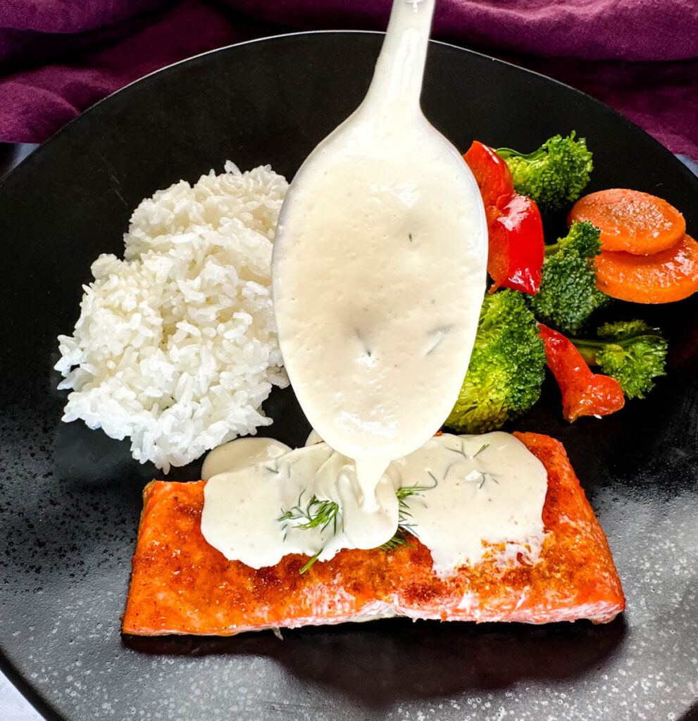 creamy homemade dill sauce on a salmon fillet