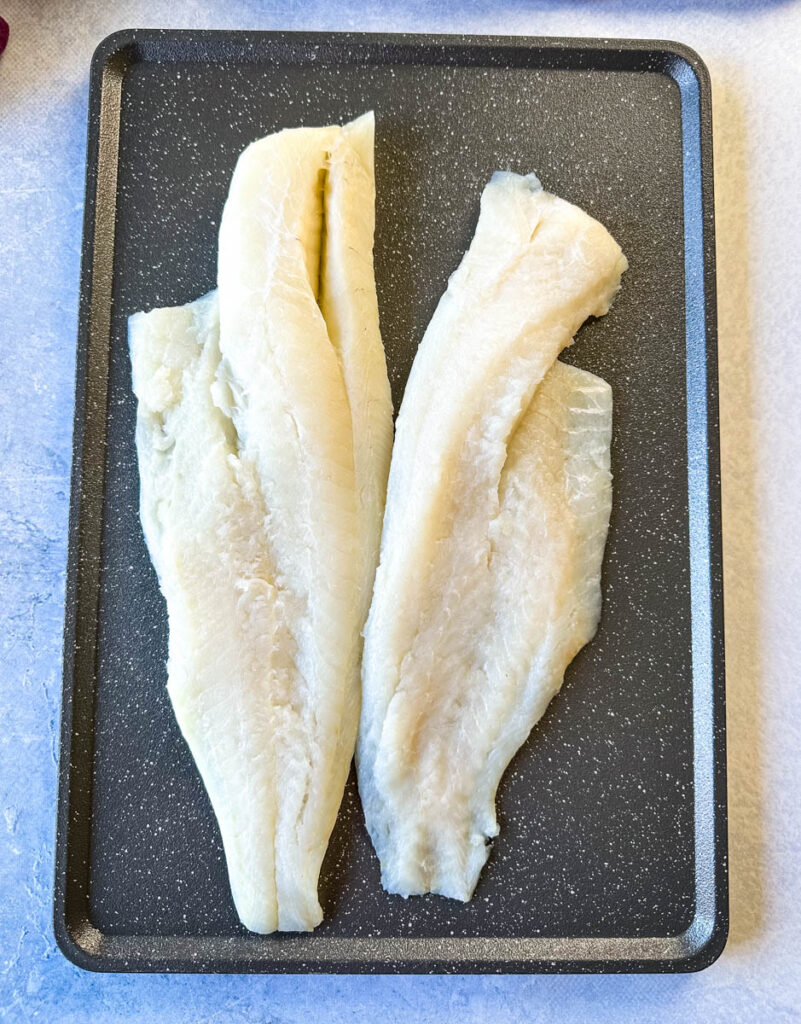 raw cod on a sheet pan