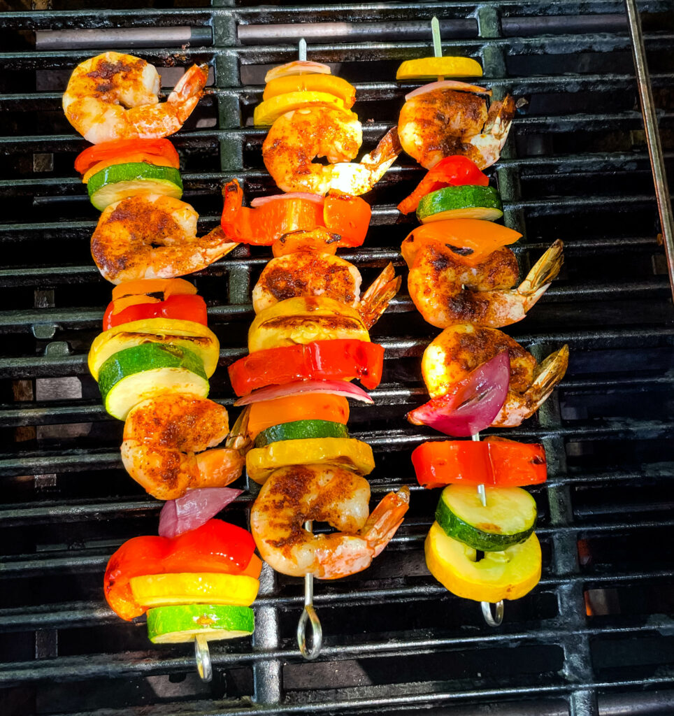 shrimp skewer kebabs and vegetables on a grill