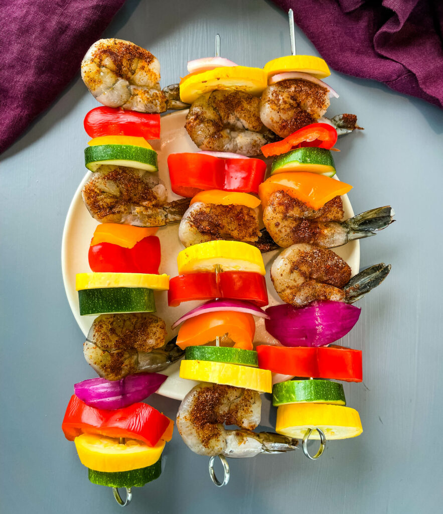 raw shrimp on skewers with vegetables