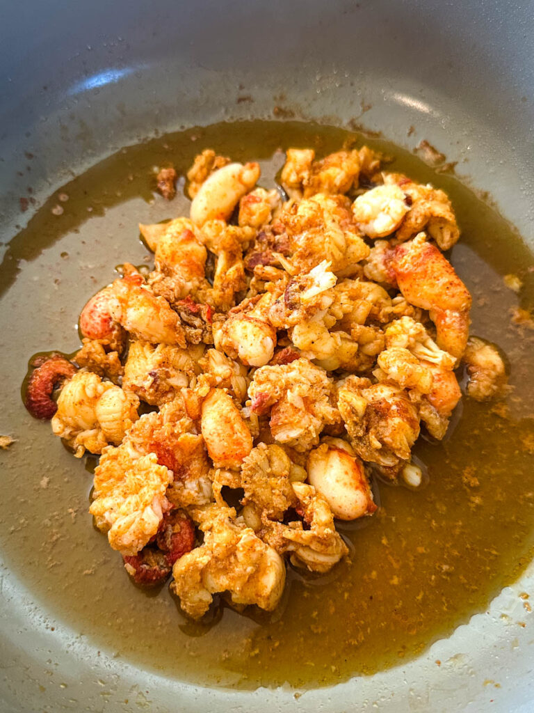 lobster meat seasoned with taco seasoning in a pan