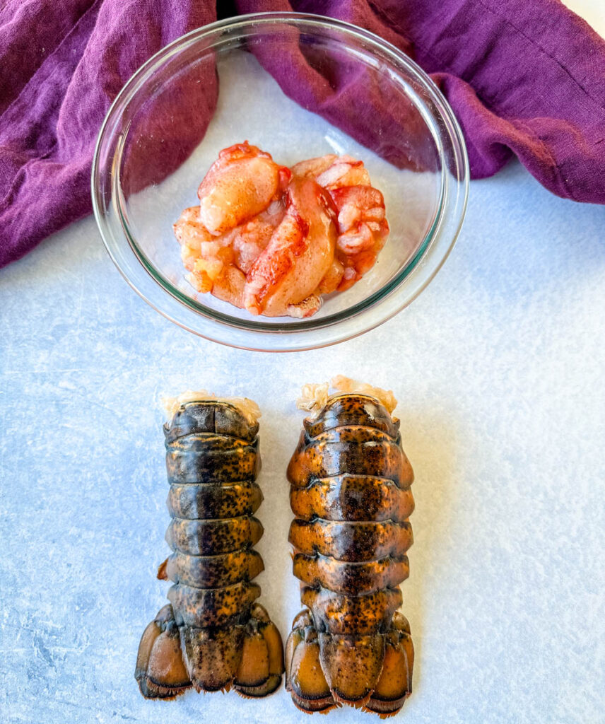 lobster tails and lobster knuckle and claw meat in a glass bowl