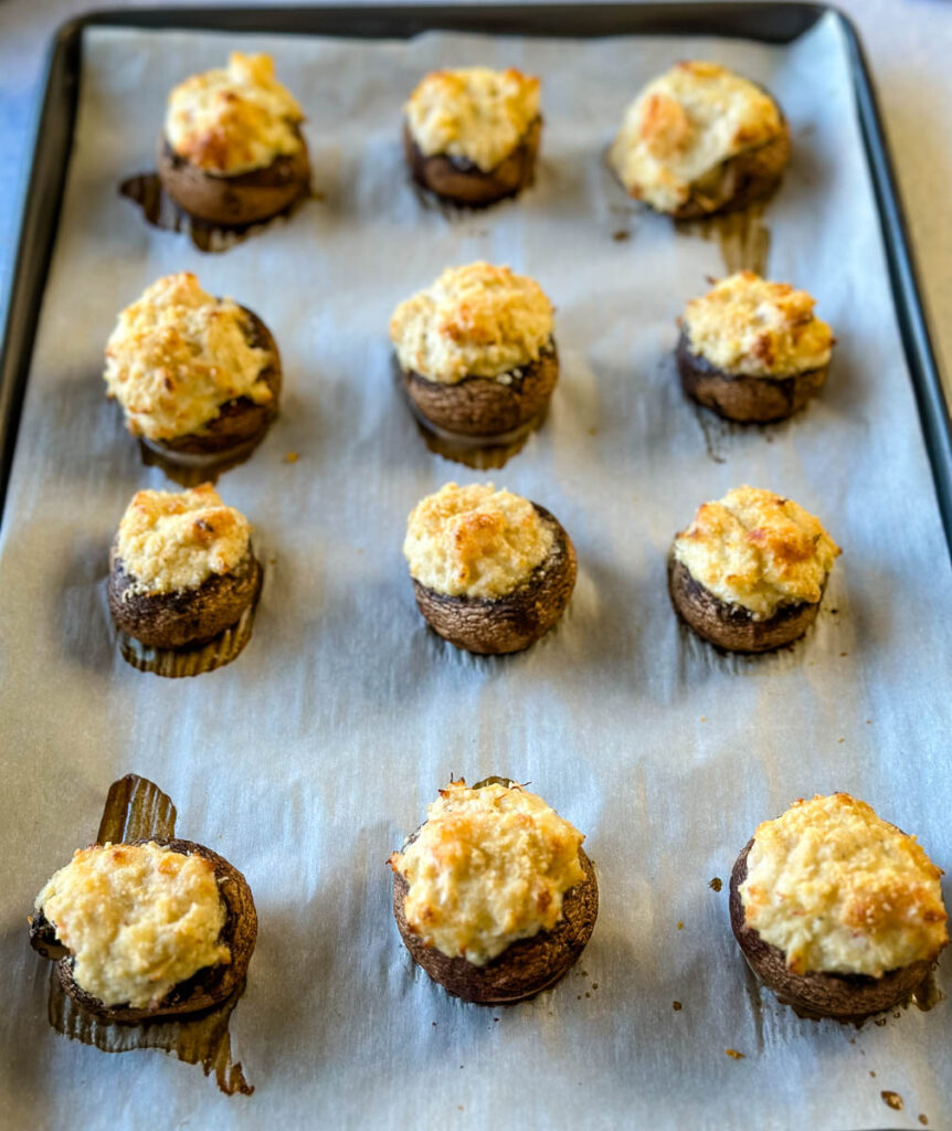 baked seafood stuffed mushrooms with crab and shrimp on a sheet pan