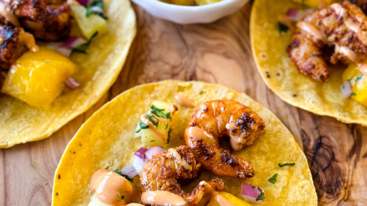 shrimp tacos with corn tortillas, avocado, and mango salsa