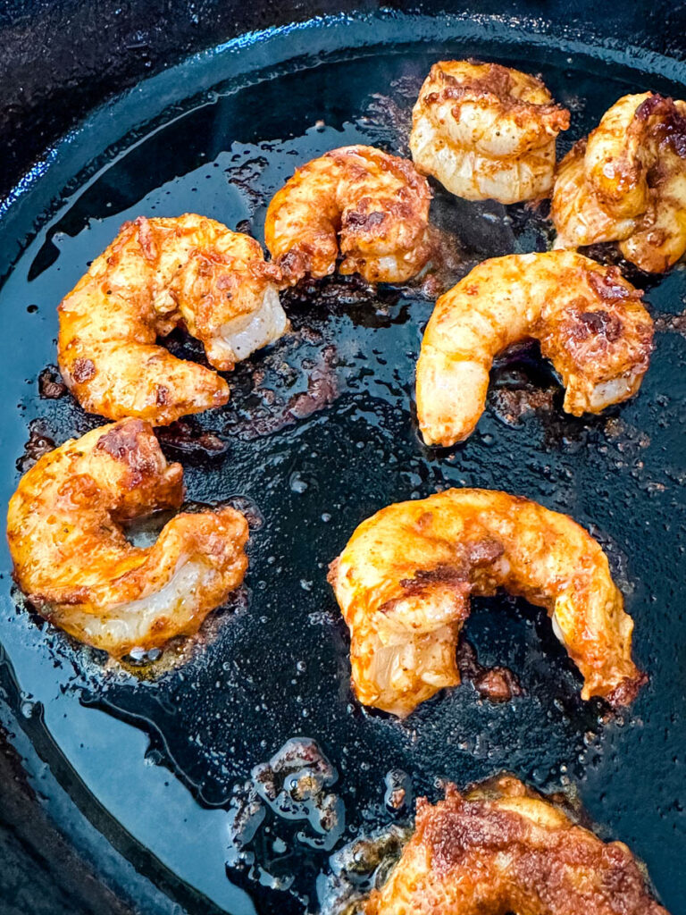 seared shrimp in a cast iron skillet with taco seasoning