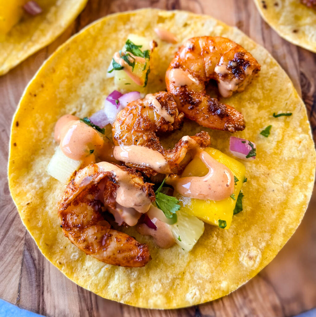 shrimp tacos with corn tortillas, avocado, and mango salsa