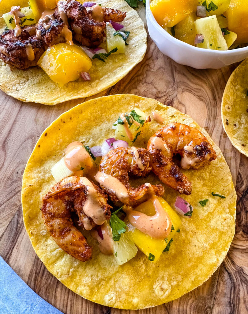 shrimp tacos with corn tortillas, avocado, and mango salsa