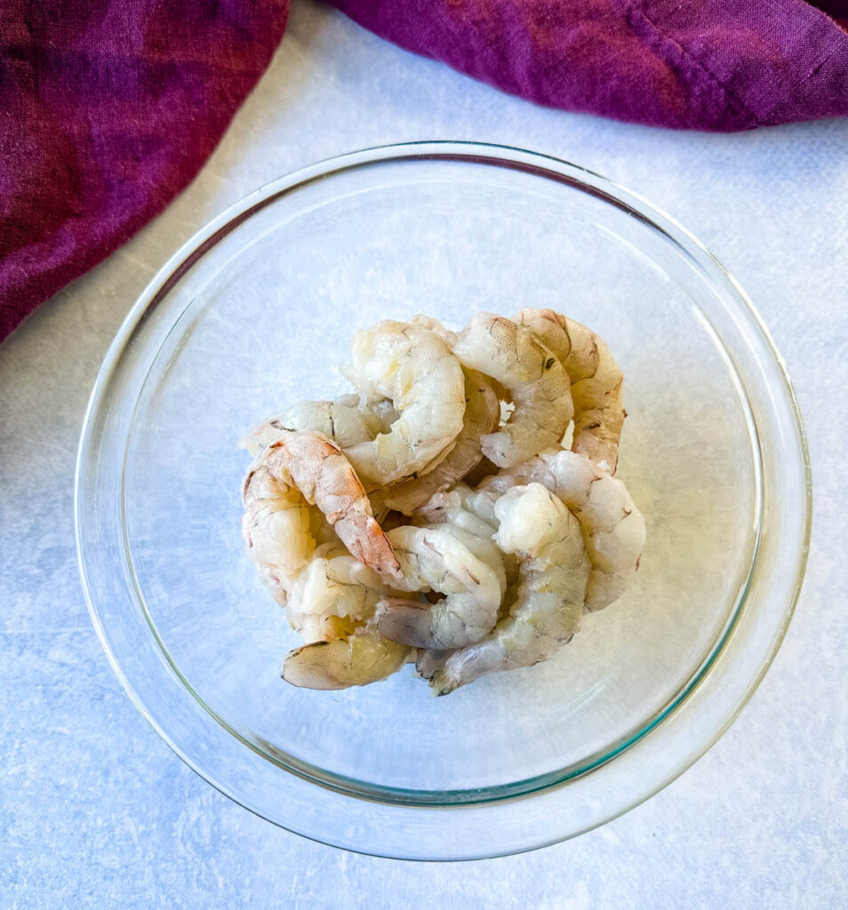 raw, peeled shrimp in a glass bowl