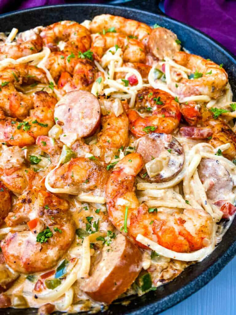 Cajun shrimp pasta with linguine, sausage, and cream sauce in a pan