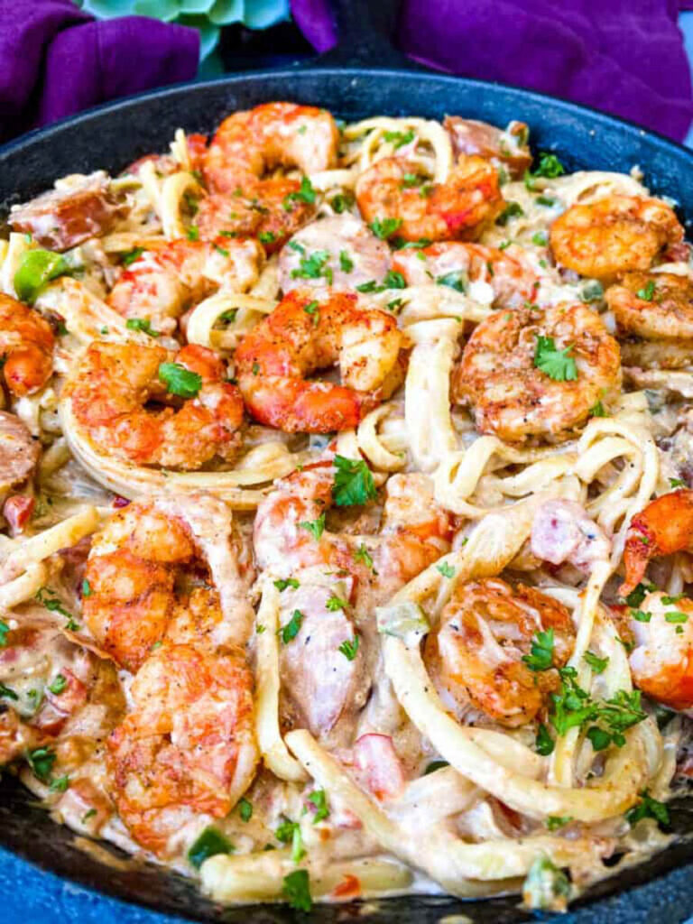 Cajun shrimp pasta with linguine, sausage, and cream sauce in a pan