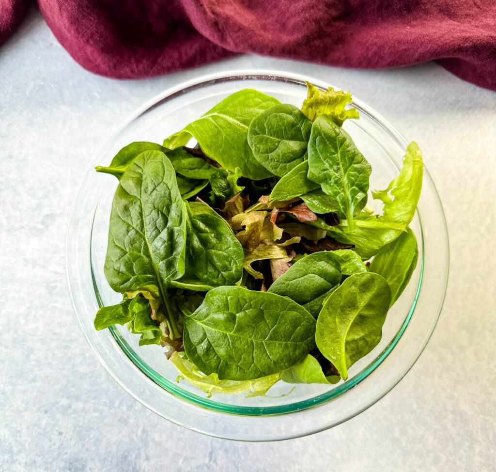 mixed greens in a glass bowl