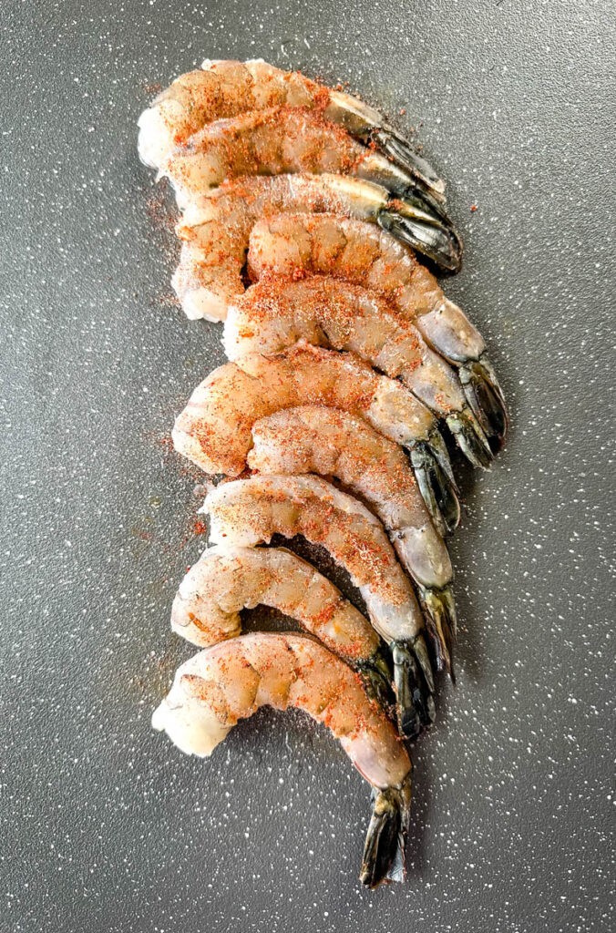 seasoned raw shrimp on a sheet pan