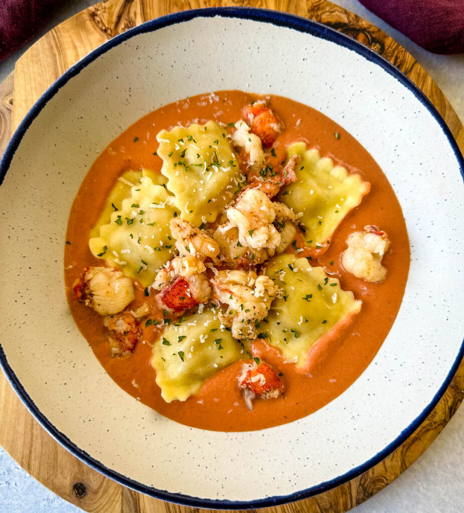 lobster ravioli with tomato cream sauce in a white bowl