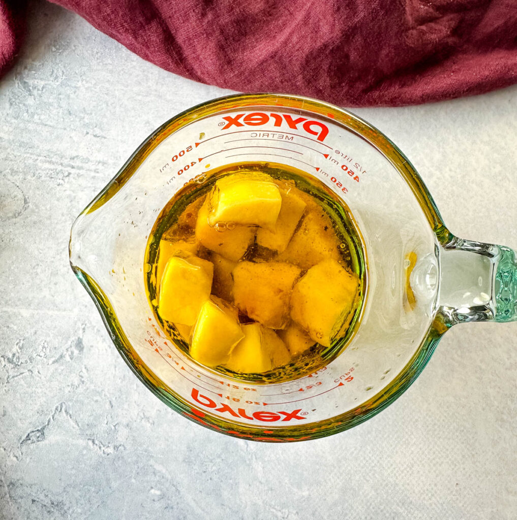 mangos, balsamic vinegar, olive oil, and lime in a glass bowl