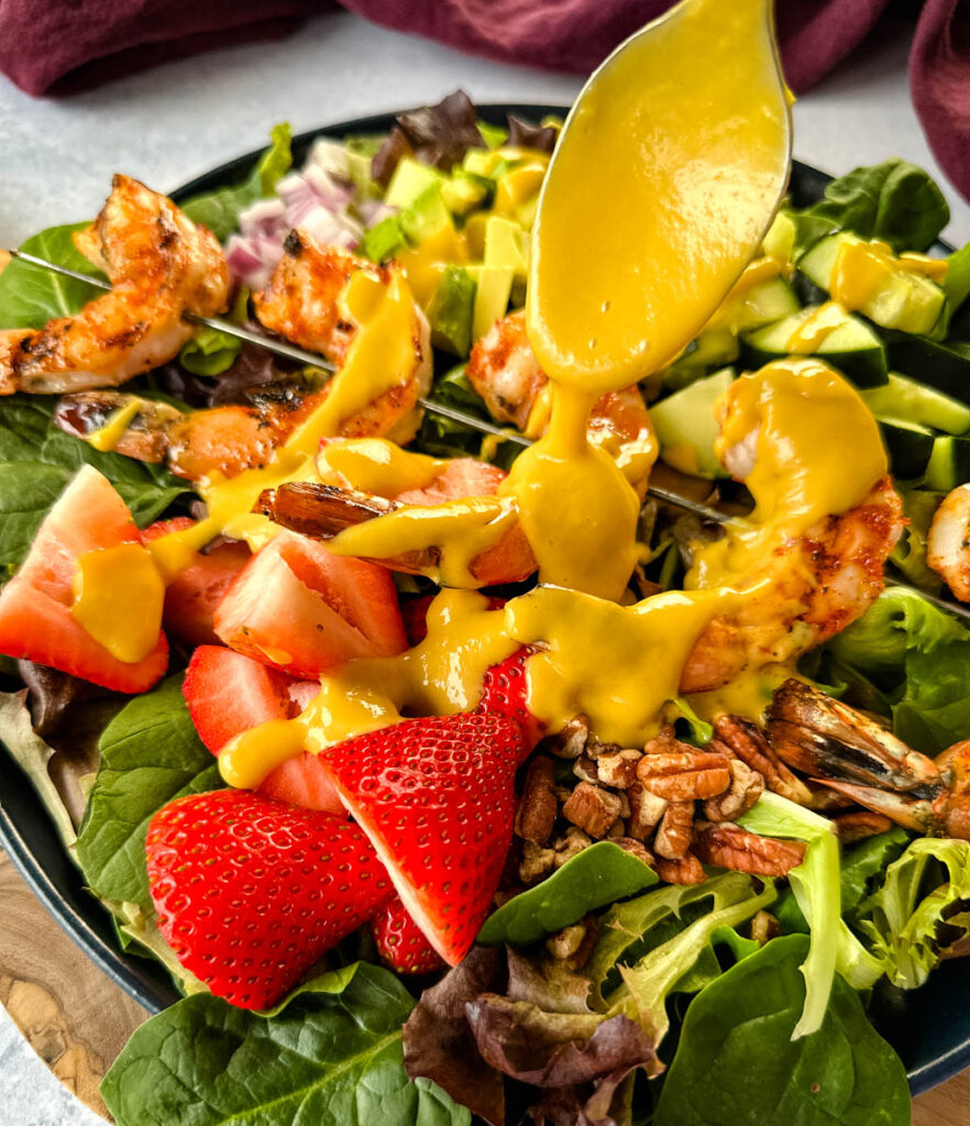 grilled shrimp salad drizzled with mango salad dressing