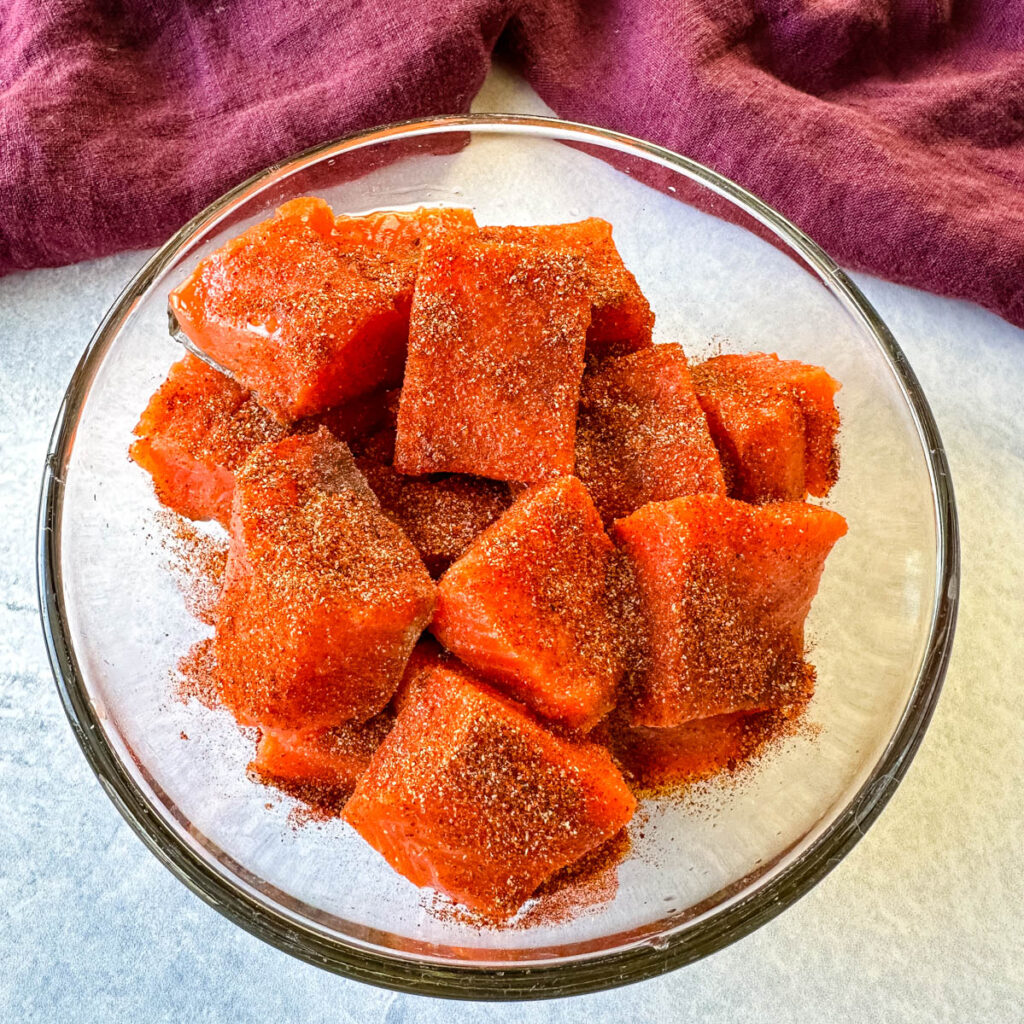 raw salmon sliced into chunks/bites seasoned with spices