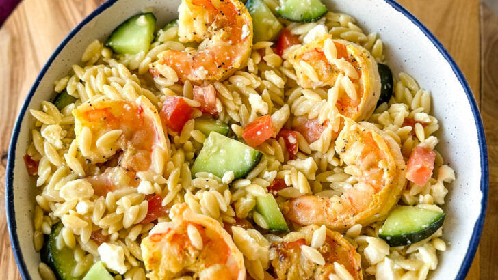 shrimp orzo pasta salad with Italian Dressing and vegetables in a white bowl