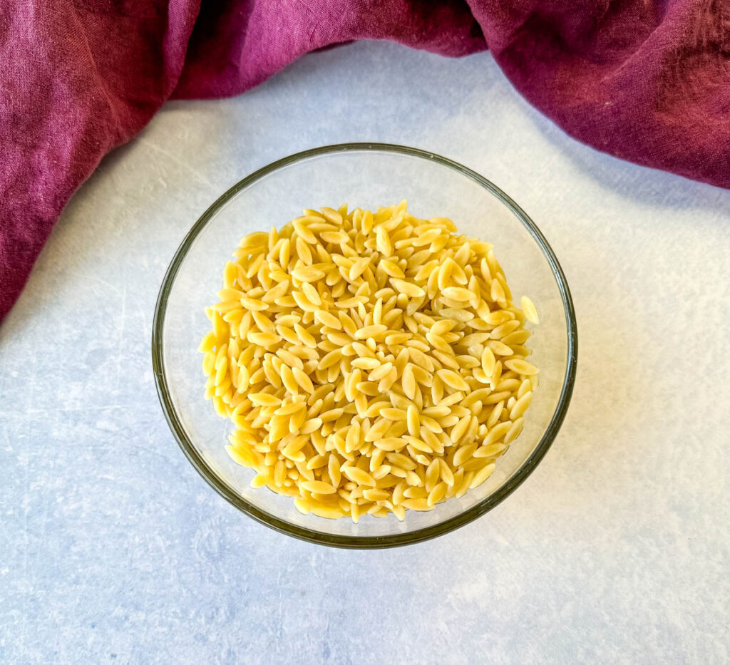 dry orzo pasta in a white bowl