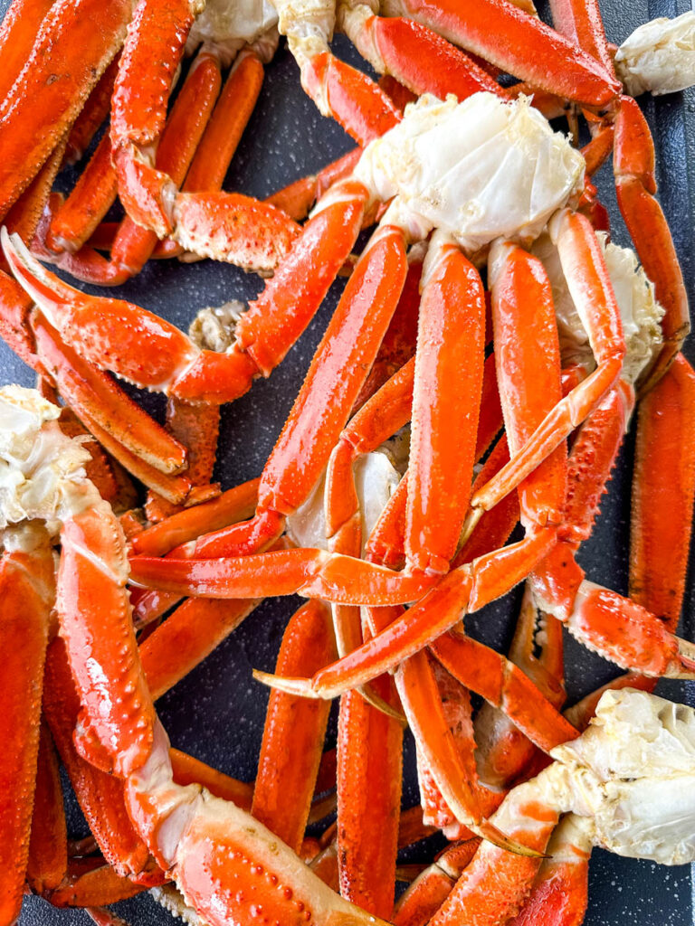 smoked crab legs on a sheet pan