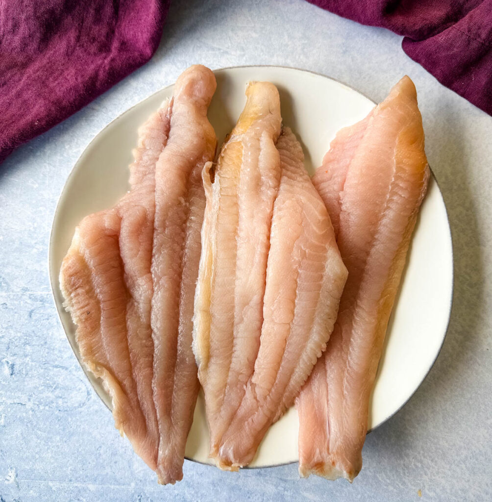 raw catfish fillets on a plate
