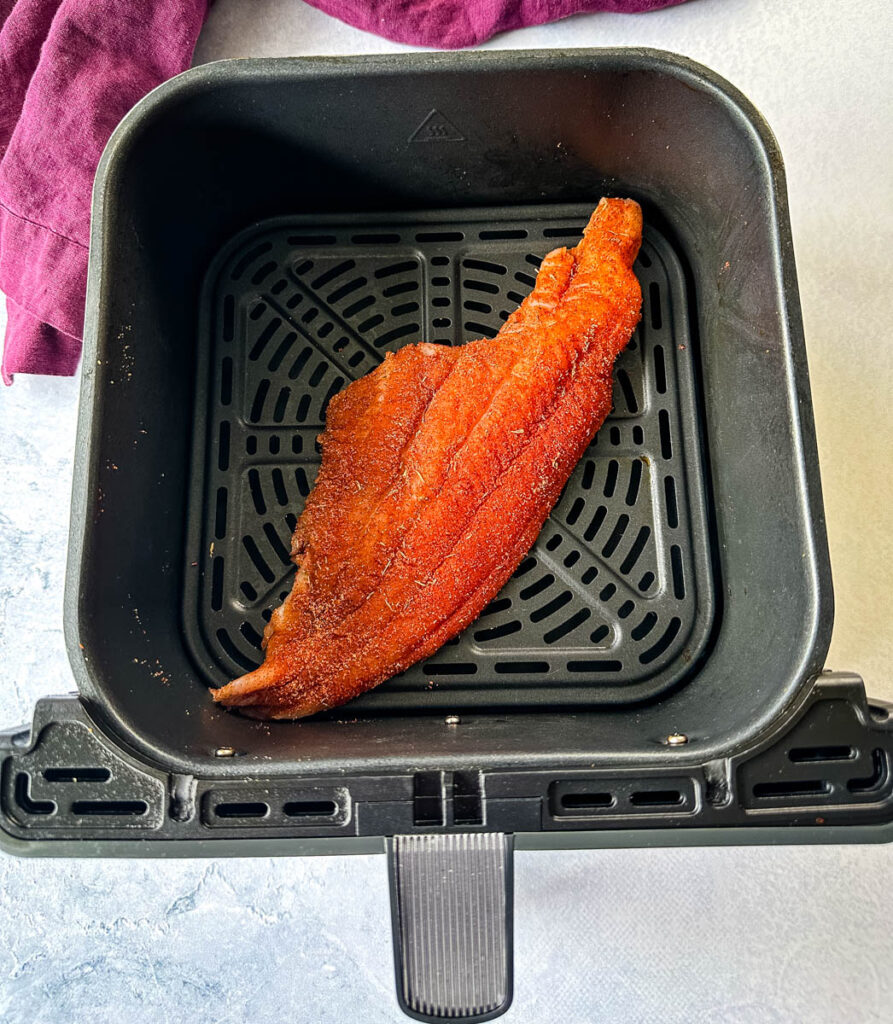 raw seasoned catfish in an air fryer