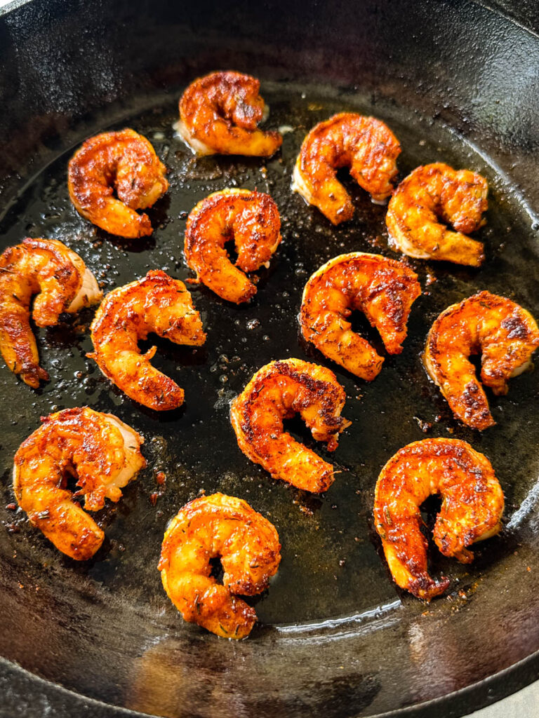 blackened shrimp seared in a cast iron skillet