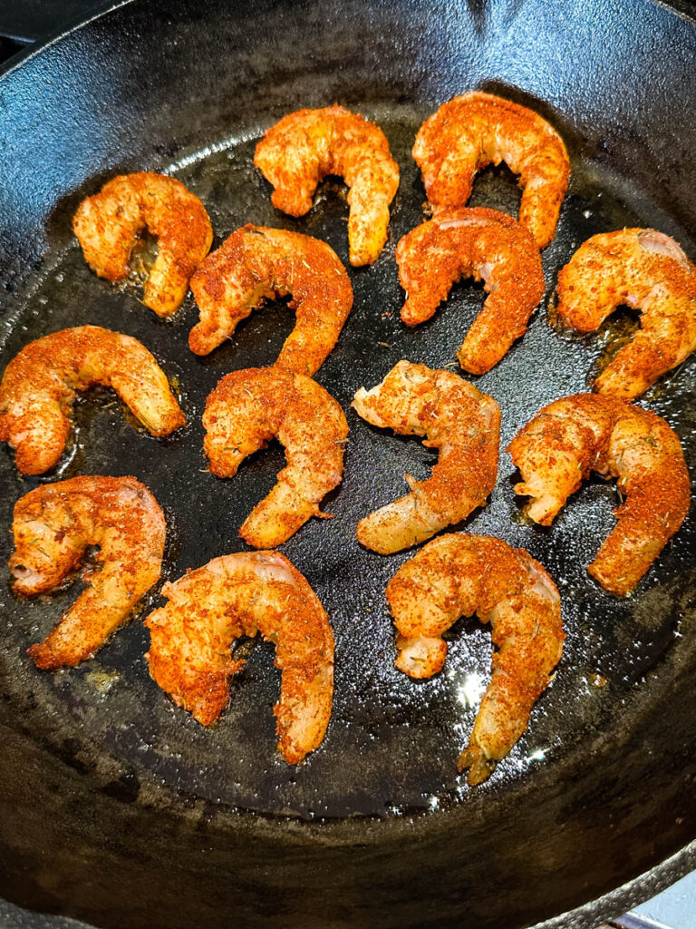 blackened shrimp seared in a cast iron skillet