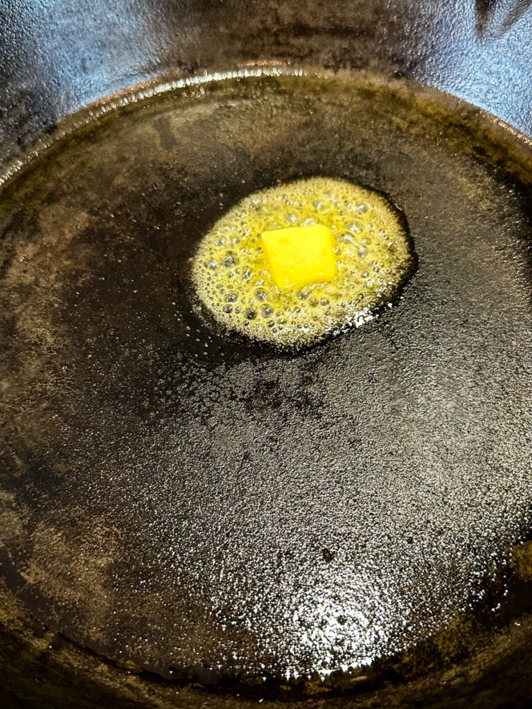 melted butter in a cast iron skillet