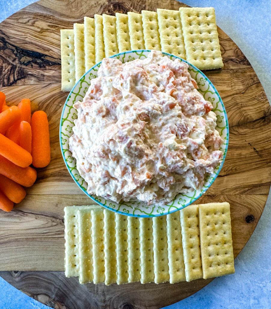 smoked fish dip with salmon, crackers, and carrots on a plate