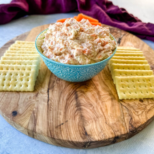 smoked fish dip with salmon, crackers, and carrots on a plate